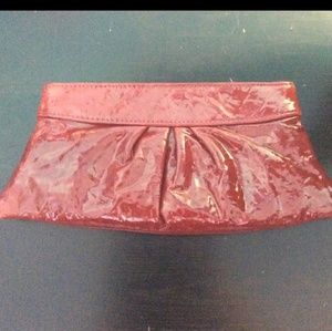 Shiny red leather clutch